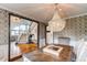 Formal dining room with elegant chandelier, patterned wallpaper, and view to staircase at 10393 Deerfield Rd, Franktown, CO 80116