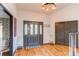 Inviting foyer with hardwood floors, decorative lighting, and a stylish front door at 10393 Deerfield Rd, Franktown, CO 80116