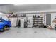 Spacious garage features ample storage shelving, a refrigerator, and plenty of room for projects at 10393 Deerfield Rd, Franktown, CO 80116