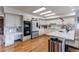 Elegant kitchen with white cabinets, stainless steel appliances, hardwood floors, and a large island at 10393 Deerfield Rd, Franktown, CO 80116