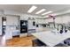 Bright kitchen with white cabinetry, center island with marble countertops, and stainless steel appliances at 10393 Deerfield Rd, Franktown, CO 80116