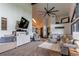 Spacious living room featuring a plush sofa, stylish ottoman, and modern decor elements at 10393 Deerfield Rd, Franktown, CO 80116