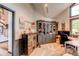 Comfortable home office featuring a large desk, display cabinet, and natural light at 10393 Deerfield Rd, Franktown, CO 80116