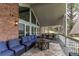Covered patio with comfortable seating, a fire pit table, and brick accents at 10393 Deerfield Rd, Franktown, CO 80116