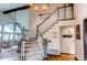 Elegant staircase leading to the upper level with decorative accents and natural light at 10393 Deerfield Rd, Franktown, CO 80116