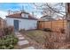 Backyard with a detached garage and stepping stone path, showcasing the outdoor space and potential at 3339 Tejon St, Denver, CO 80211