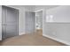 Bedroom featuring gray trim and doors, neutral carpet, and a view of a powder room at 3339 Tejon St, Denver, CO 80211