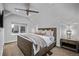 Cozy bedroom with a wood-framed bed, ceiling fan, window and neutral color scheme at 3339 Tejon St, Denver, CO 80211