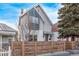 Two-story home with unique architectural details, including a modern window design and wood fence at 3339 Tejon St, Denver, CO 80211