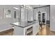 Kitchen island featuring stainless steel oven, pendant lighting, and adjacent dining space with outdoor access at 3339 Tejon St, Denver, CO 80211