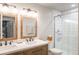 Bright bathroom features a double vanity with a glass-enclosed shower at 2572 Iola St, Aurora, CO 80010