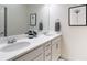 Bathroom featuring double sink vanity with modern fixtures and ample storage at 2572 Iola St, Aurora, CO 80010