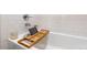 Close up of modern bathroom with a luxurious tub and wooden bath caddy at 2572 Iola St, Aurora, CO 80010