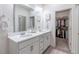 Bathroom features a double vanity, spacious mirror, and closet at 2572 Iola St, Aurora, CO 80010