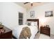 Bedroom with white walls, white bedding, and a dark wood nightstand at 2572 Iola St, Aurora, CO 80010