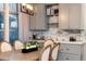 Elegant dining area with a wooden table, comfortable chairs, and stylish lighting fixture at 2572 Iola St, Aurora, CO 80010