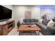 Inviting living room features a comfortable gray sectional sofa, fireplace, and a rustic wooden coffee table at 2572 Iola St, Aurora, CO 80010