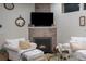 Inviting living room with a fireplace, neutral color palette, and comfortable seating for relaxation and entertainment at 2572 Iola St, Aurora, CO 80010