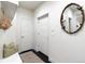 Functional mudroom featuring white storage bench, hooks, and dark wood floors providing a stylish and organized entryway at 2572 Iola St, Aurora, CO 80010