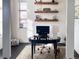 Home office featuring a desk, shelves, and a window providing natural light for a productive workspace at 2572 Iola St, Aurora, CO 80010