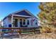 Home exterior showing a covered patio area with outdoor furniture and wood fence at 3375 Starry Night Loop, Castle Rock, CO 80109