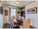 Elegant dining room with a large wooden table and tufted chairs adjacent to the kitchen at 3375 Starry Night Loop, Castle Rock, CO 80109