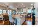 Kitchen with a granite island, adjacent to a cozy living room with a fireplace and sliding glass doors at 3375 Starry Night Loop, Castle Rock, CO 80109