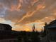 Beautiful sunset casting orange and gold hues over the neighborhood homes and horizon at 3375 Starry Night Loop, Castle Rock, CO 80109