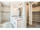 Bathroom featuring double sinks, granite countertops, modern fixtures, and a walk-in shower at 701 E 24Th Ave, Denver, CO 80205