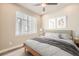 Comfortable bedroom features a plush bed, natural light, and simple decor at 701 E 24Th Ave, Denver, CO 80205