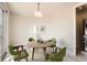 Cozy dining area with round wooden table, four green chairs, and natural lighting at 701 E 24Th Ave, Denver, CO 80205