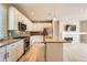 Contemporary kitchen with stainless steel appliances, a stylish backsplash, and an island at 701 E 24Th Ave, Denver, CO 80205