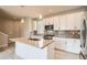 Bright kitchen featuring stainless steel appliances, an island, and pendant lighting at 701 E 24Th Ave, Denver, CO 80205