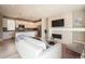 Open-concept living room features a fireplace, a mounted TV, and seamless flow into the kitchen at 701 E 24Th Ave, Denver, CO 80205