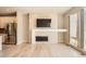 Bright living room with a modern fireplace, built-in shelving, and large windows at 701 E 24Th Ave, Denver, CO 80205