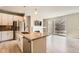 Open-concept living room and kitchen featuring hardwood floors, fireplace, and stainless steel appliances at 701 E 24Th Ave, Denver, CO 80205