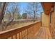 Wooden balcony showcasing the views of trees and a neighborhood beyond the fenced yard at 12655 W Bayaud Ave # 40, Lakewood, CO 80228