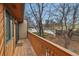 Balcony with wood railing and view of trees and a street in a quiet neighborhood at 12655 W Bayaud Ave # 40, Lakewood, CO 80228