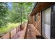 Private balcony with wood railing overlooking a well-maintained lawn and mature trees at 12655 W Bayaud Ave # 40, Lakewood, CO 80228