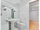 This bathroom features a pedestal sink and an abundance of tile at 12655 W Bayaud Ave # 40, Lakewood, CO 80228