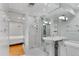 A bright bathroom featuring a standing sink, walk-in shower, and adjacent bedroom at 12655 W Bayaud Ave # 40, Lakewood, CO 80228