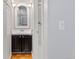 Bathroom featuring a vanity with a white countertop, dark cabinets, and a decorative mirror with lighting at 12655 W Bayaud Ave # 40, Lakewood, CO 80228