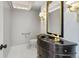 Powder room featuring elegant vanity and a decorative mirror at 12655 W Bayaud Ave # 40, Lakewood, CO 80228