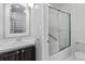 Bathroom featuring a vanity with a large mirror, and a shower with glass doors at 12655 W Bayaud Ave # 40, Lakewood, CO 80228