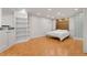Cozy bedroom with hardwood floors, built-in shelving, and a panel accent wall at 12655 W Bayaud Ave # 40, Lakewood, CO 80228