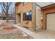 Close up on the exterior featuring warm siding and a two-car garage at 12655 W Bayaud Ave # 40, Lakewood, CO 80228