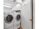 Clean laundry room featuring a modern washer and dryer with a white door at 12655 W Bayaud Ave # 40, Lakewood, CO 80228