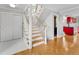 Wooden staircase with white risers and railings next to a closet and doorway at 12655 W Bayaud Ave # 40, Lakewood, CO 80228