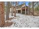 Back exterior view of home with walkout basement, deck, and snowy surroundings at 1662 Gore Dr, Larkspur, CO 80118