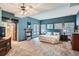 Spacious bedroom with a fireplace, large windows, and carpet floors at 1662 Gore Dr, Larkspur, CO 80118